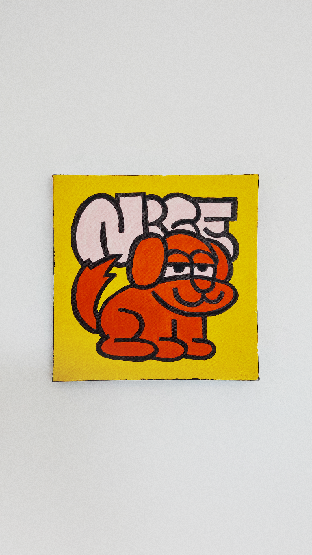 A relaxed orange dog below pale pink Nice lettering on a yellow acrylic-painted canvas.