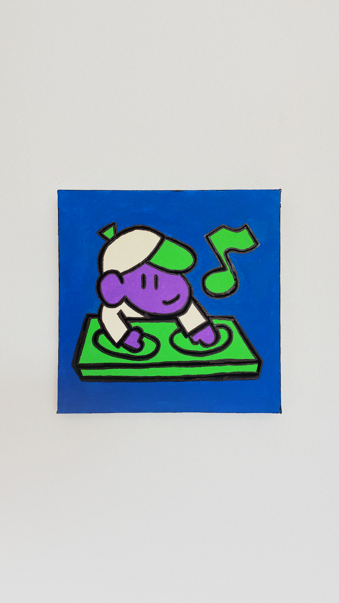 A smiling purple character wearing a cap and mixing music on green turntables against a blue background.