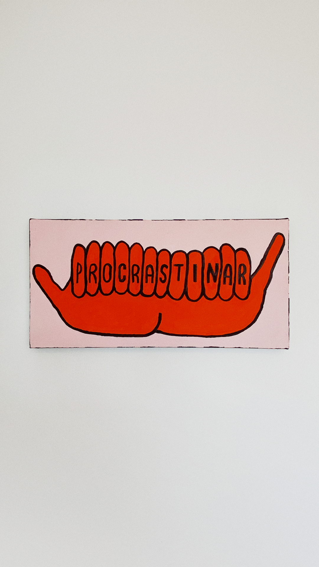 Orange feet with the Portuguese word for 'procrastinate' painted across the toes on a pale pink canvas.