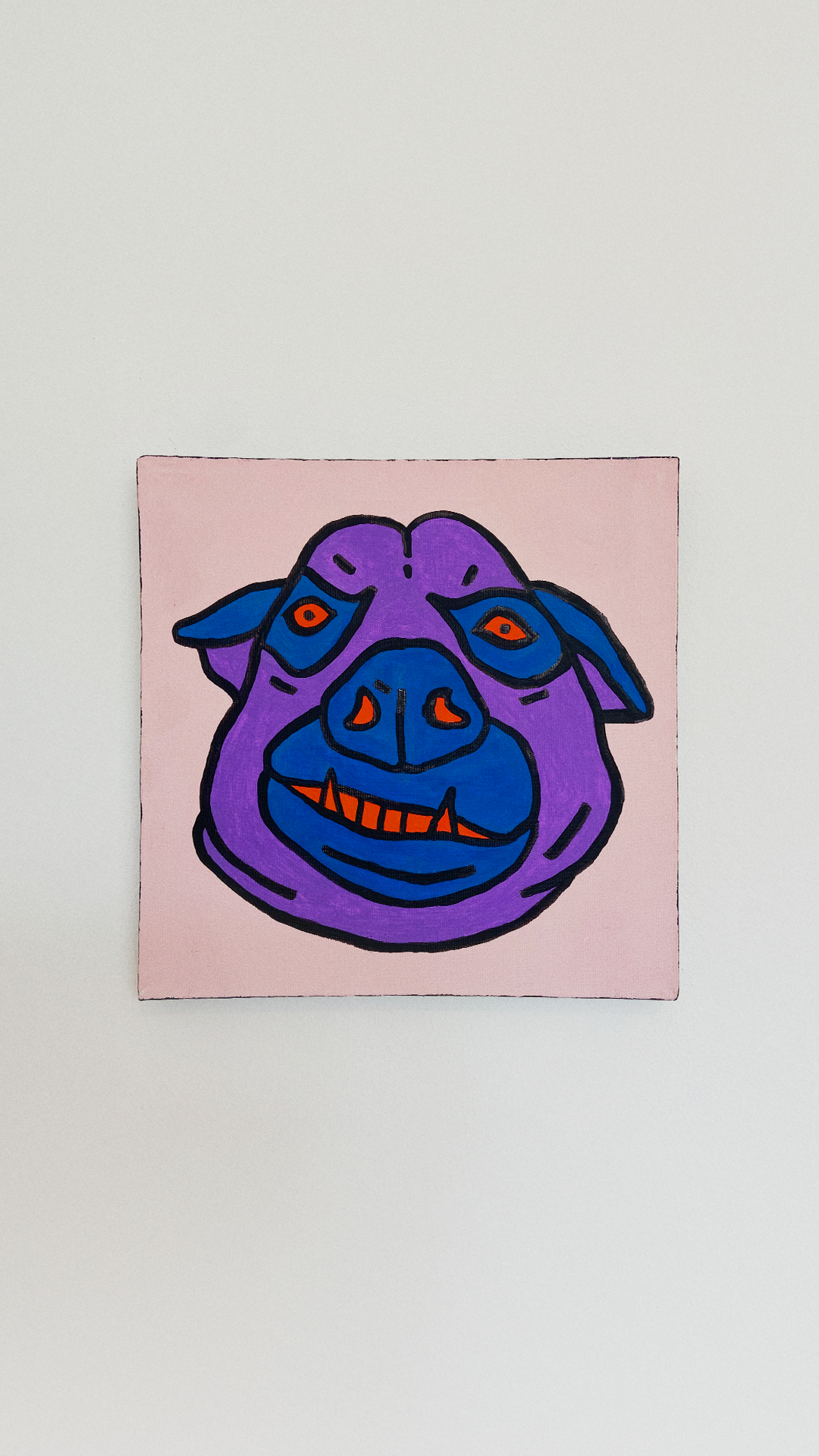 A purple and blue animal face with orange eyes and teeth, outlined in black on a pale pink canvas.