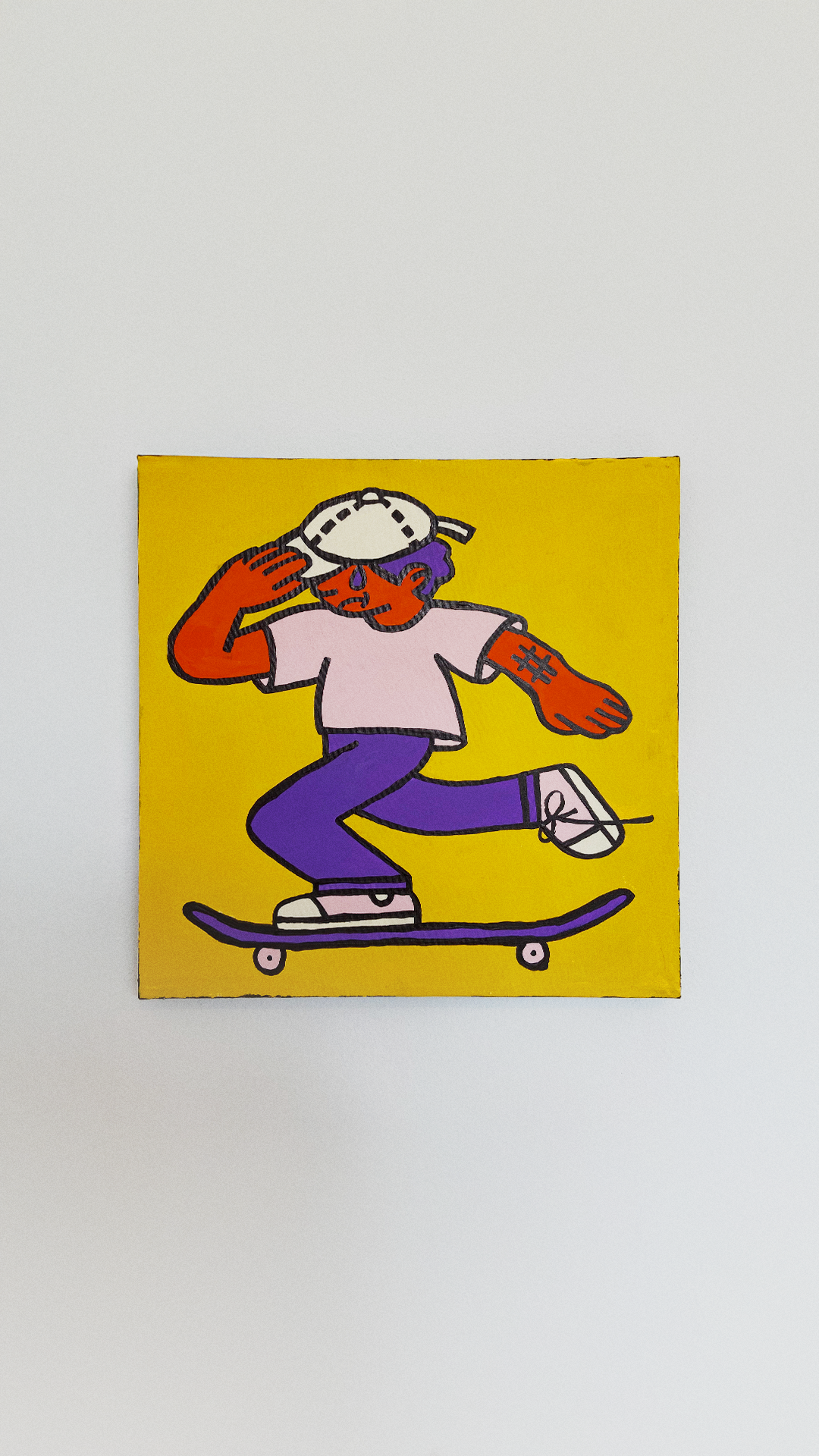 An orange skateboarder in a white cap and shirt with purple trousers, balancing on a purple board against yellow canvas.