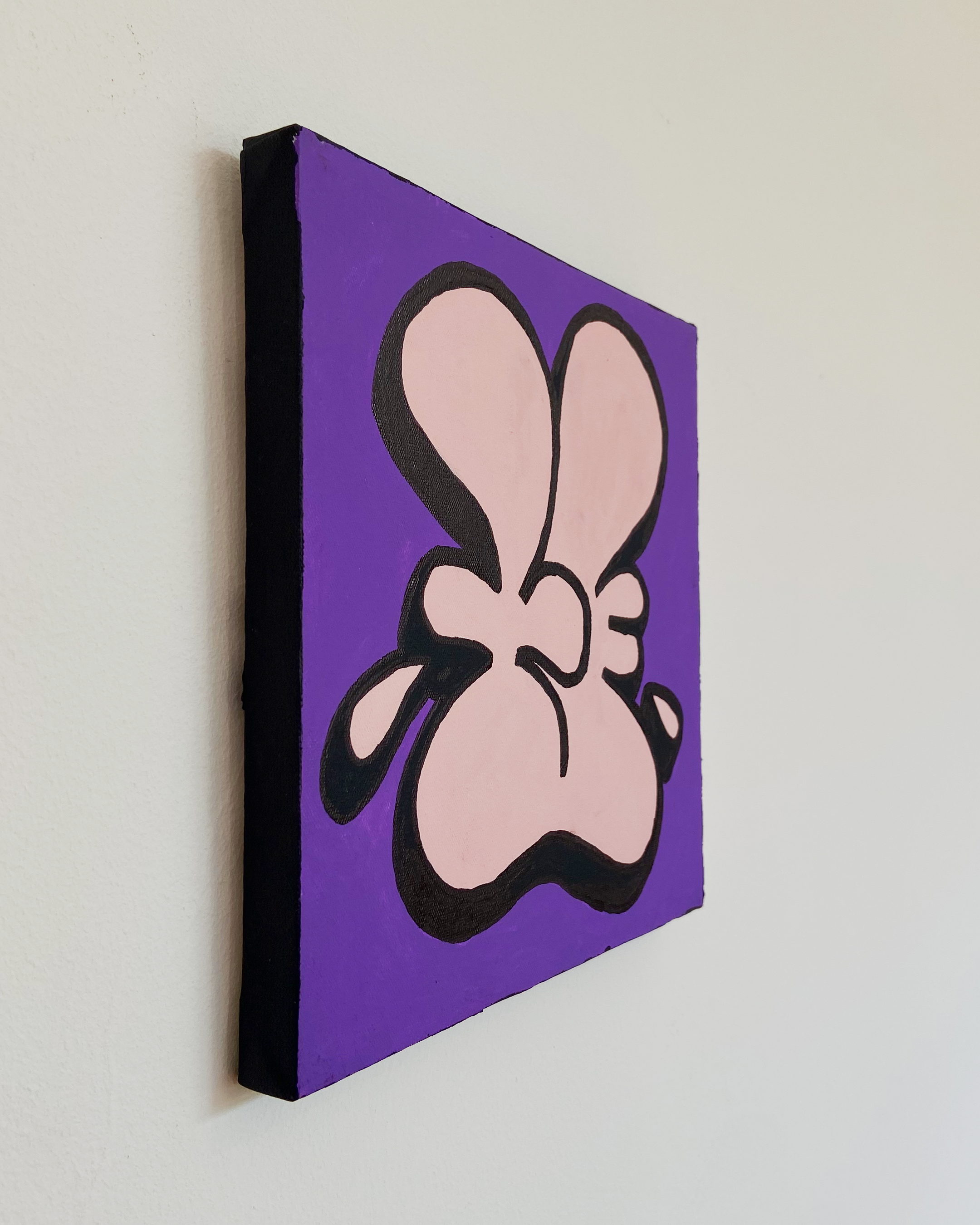 Left-side view of the Nice Studio painting showing the black canvas edge and the hand-painted pink forms and black outlines on a purple ground.