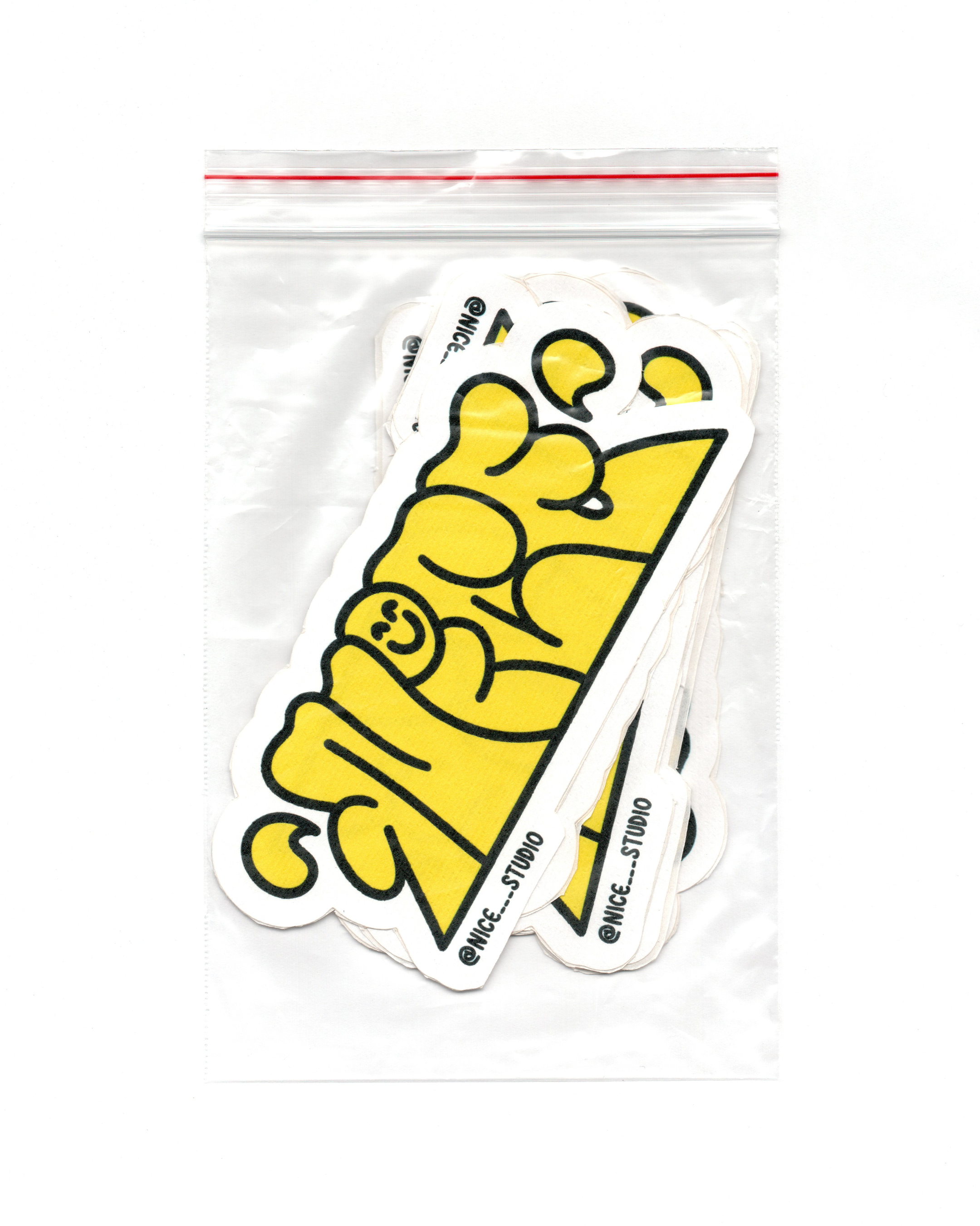 Yellow and black Nice Studio lettering stickers with white borders, photographed inside a clear resealable bag.