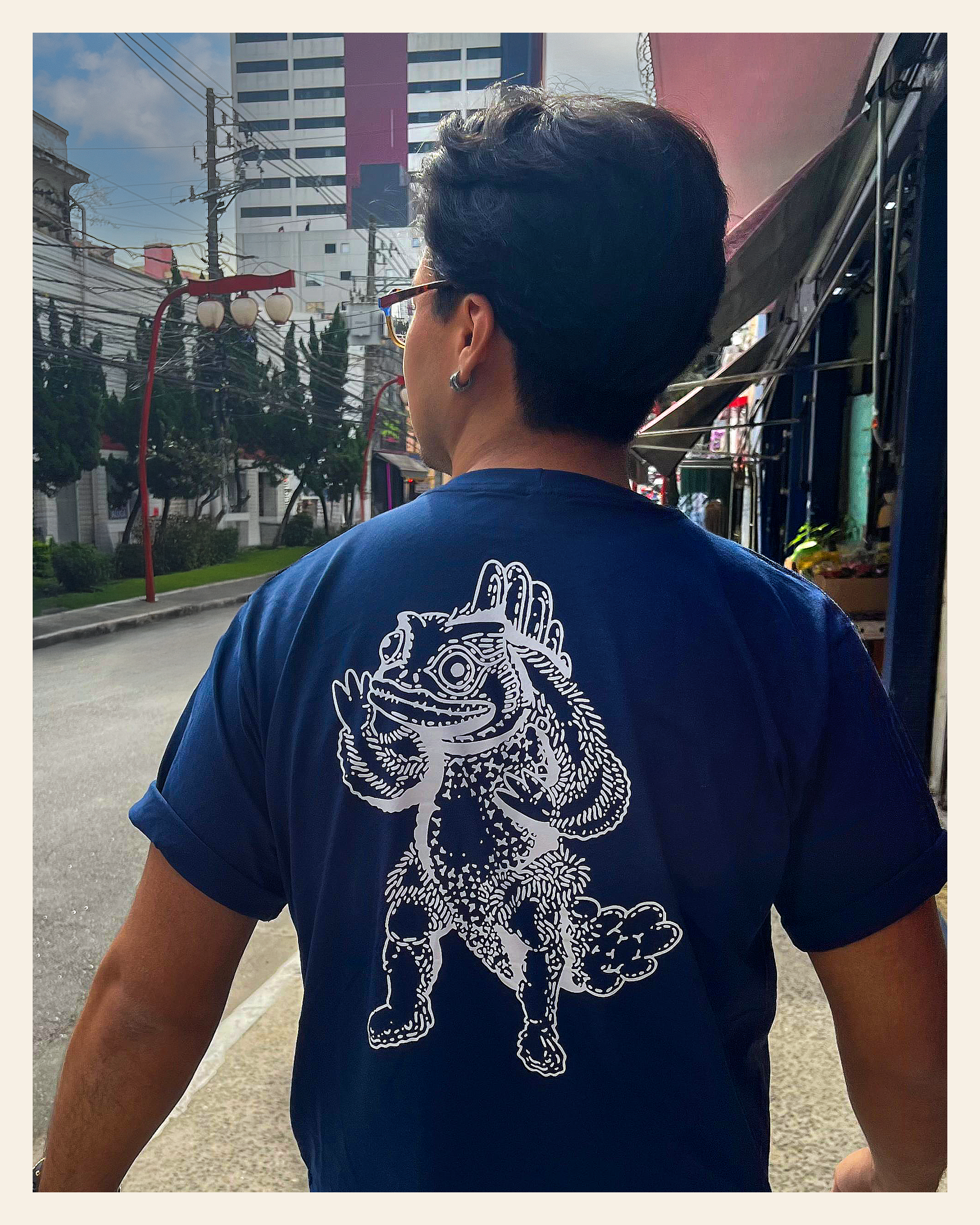Guesura T-shirt worn outdoors, showing the large illustration across the back.